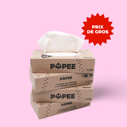 Quatre boîtes de mouchoirs Popee en carton recyclé empilées, avec mention prix de gros.